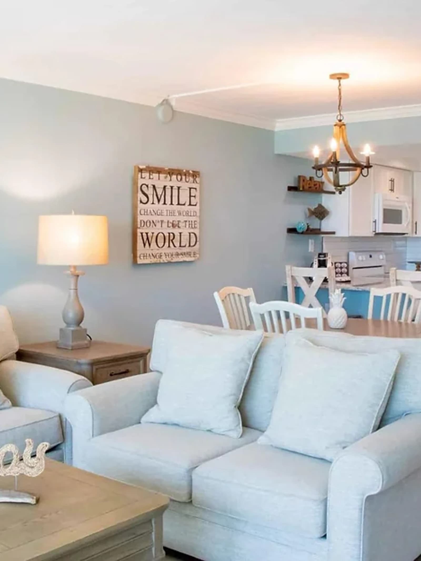 Athlete apartment — living area with seating and adjoining kitchen.
